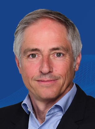 Porträtbild von Stephan Holzem vor blauem Hintergrund
